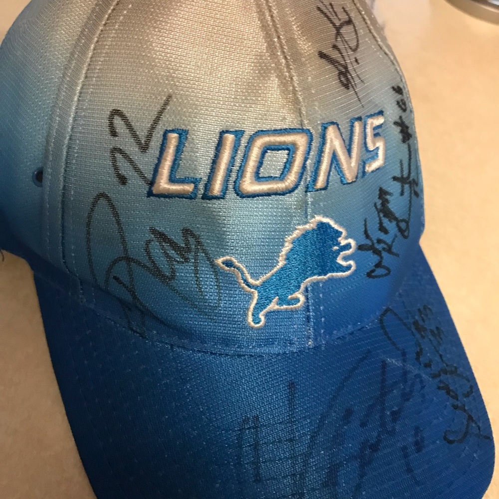 Detroit Lions autographed hats, miniature helmet and jersey.